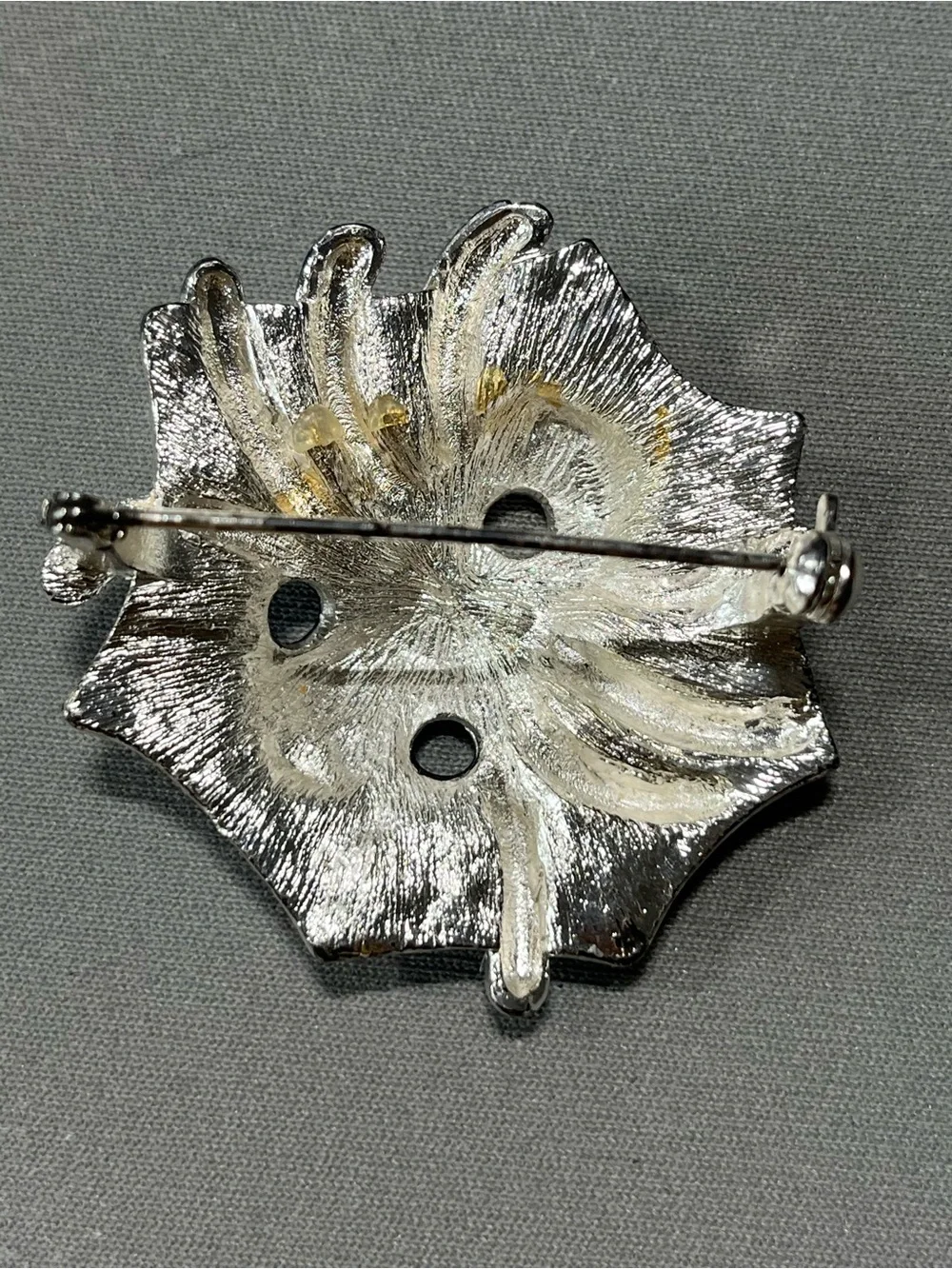 Spooky silver and black metal spider pin for Halloween.